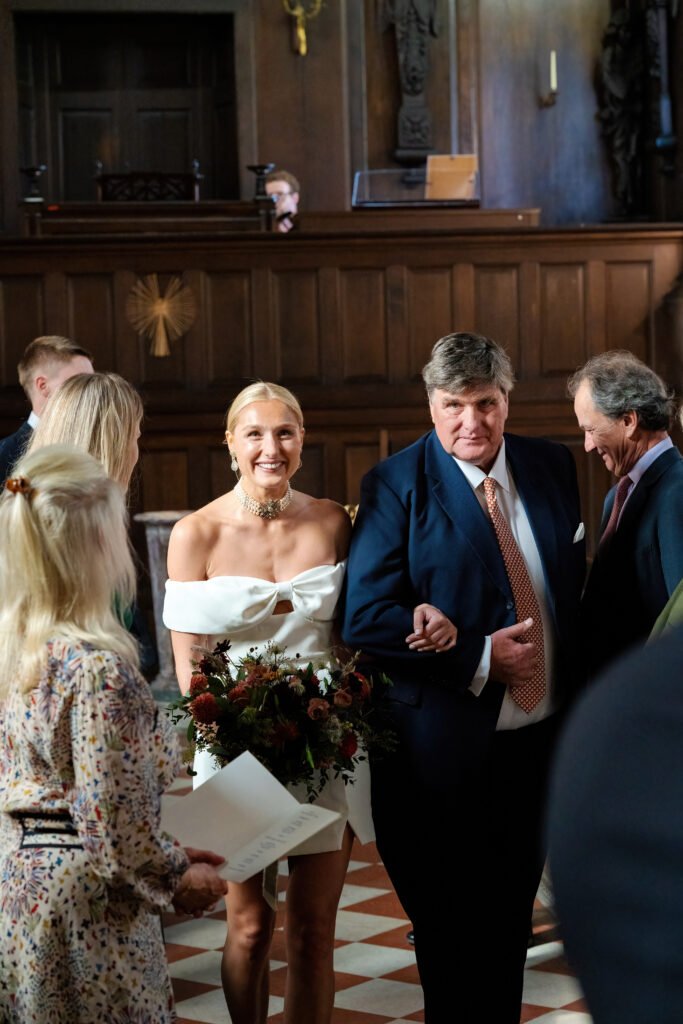 Couple posing inside Capesthorne Hall Chapel, captured by a Cheshire wedding photographer